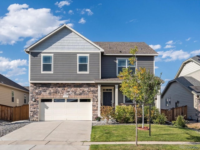 craftsman house with a garage and a front lawn