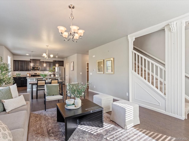 living room featuring recessed lighting, stairway, wood finished floors, a chandelier, and baseboards