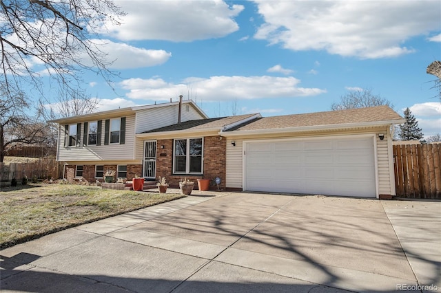 tri-level home featuring a front yard and a garage