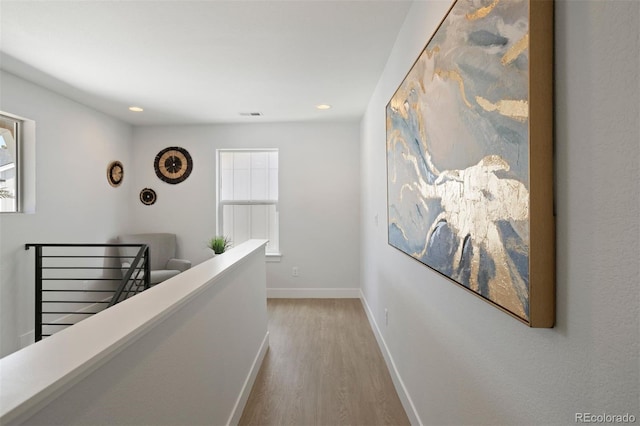 corridor with light hardwood / wood-style floors