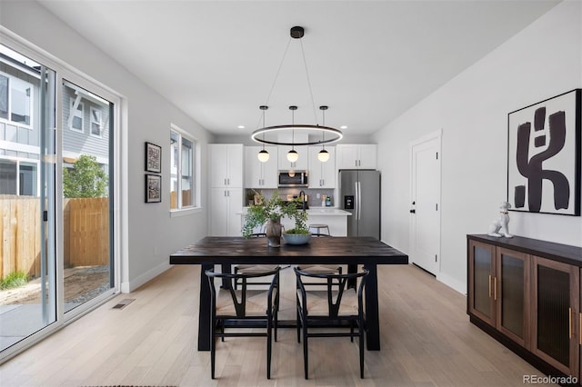 4018 Upham St, Wheat Ridge, CO 80033 - dining area featuring light wood-style flooring, baseboards, visible vents, and recessed lighting