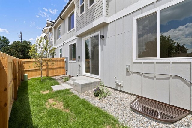 4018 Upham St, Wheat Ridge, CO 80033 - exterior space featuring board and batten siding, fence private yard, and a lawn