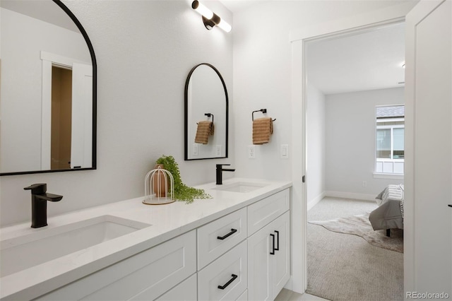 4018 Upham St, Wheat Ridge, CO 80033 - bathroom featuring baseboards, double vanity, and a sink