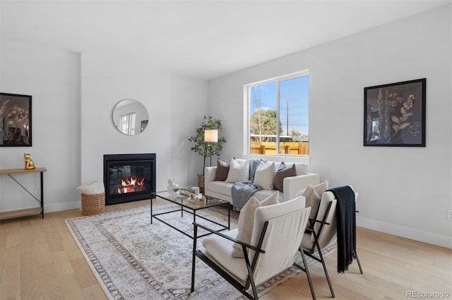 4018 Upham St, Wheat Ridge, CO 80033 - living room with light wood-type flooring, baseboards, and a glass covered fireplace