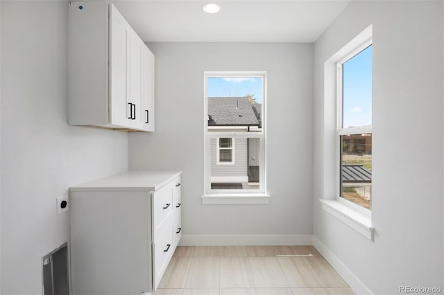 4018 Upham St, Wheat Ridge, CO 80033 - interior space featuring cabinet space, baseboards, hookup for an electric dryer, and recessed lighting