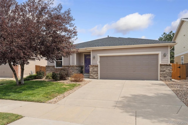 view of front of property with a front yard and a garage