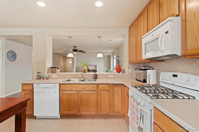 kitchen featuring kitchen peninsula, white appliances, ceiling fan, sink, and hanging light fixtures