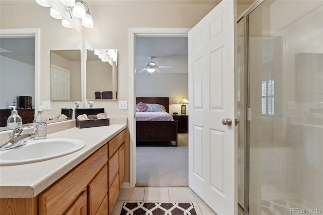 bathroom with tile patterned floors, ceiling fan, an enclosed shower, and vanity