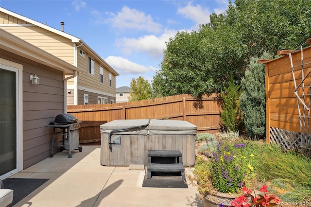 view of patio featuring area for grilling and a hot tub