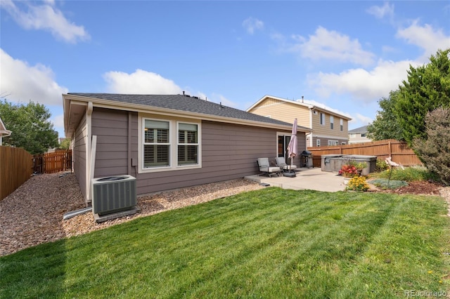 rear view of house featuring a patio area, central air condition unit, and a yard