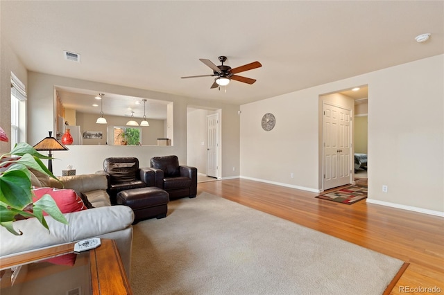 living room featuring ceiling fan and hardwood / wood-style flooring