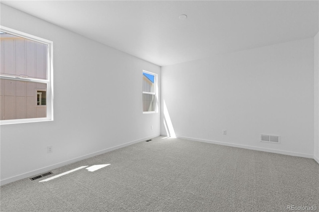 empty room with baseboards and carpet flooring