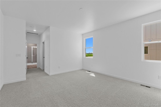 carpeted spare room with baseboards