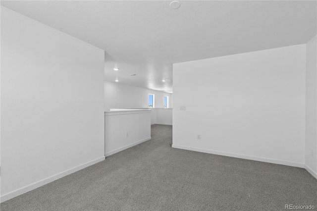 unfurnished room with carpet floors, baseboards, and recessed lighting