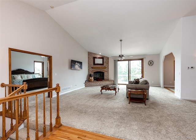 1660 Old Antlers Way, Monument, CO 80132 - living room featuring lofted ceiling, ceiling fan, a brick fireplace, and light colored carpet