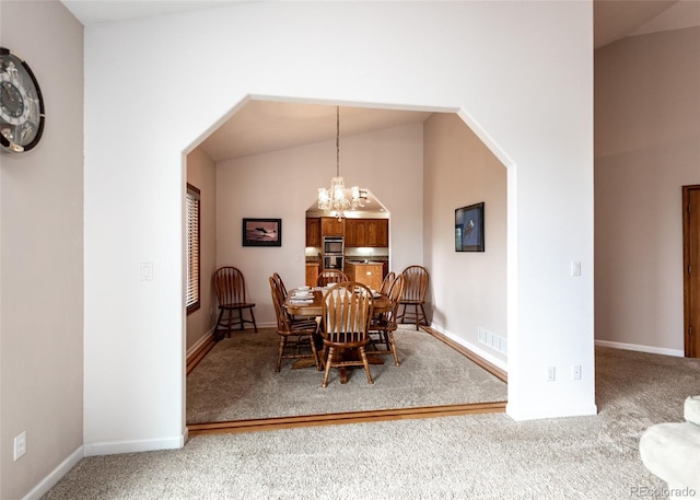 1660 Old Antlers Way, Monument, CO 80132 - carpeted dining area with a chandelier, arched walkways, and lofted ceiling