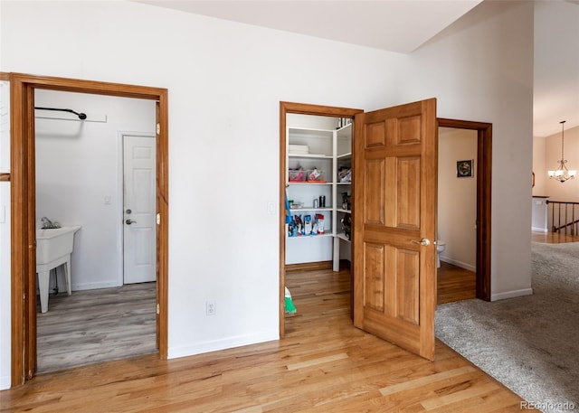 1660 Old Antlers Way, Monument, CO 80132 - hallway featuring light wood-type flooring and a chandelier