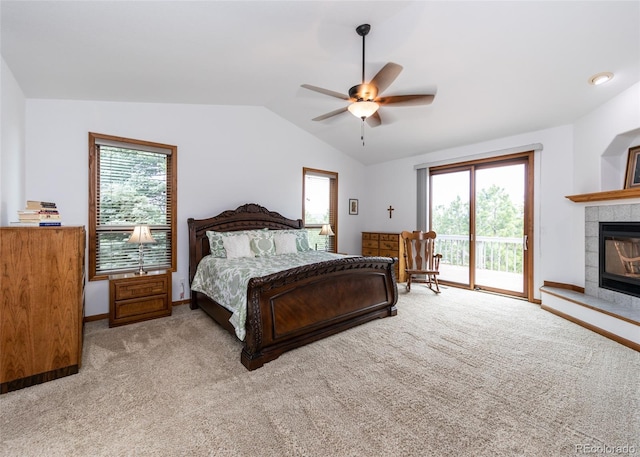 1660 Old Antlers Way, Monument, CO 80132 - carpeted bedroom with access to exterior, vaulted ceiling, a tiled fireplace, and ceiling fan
