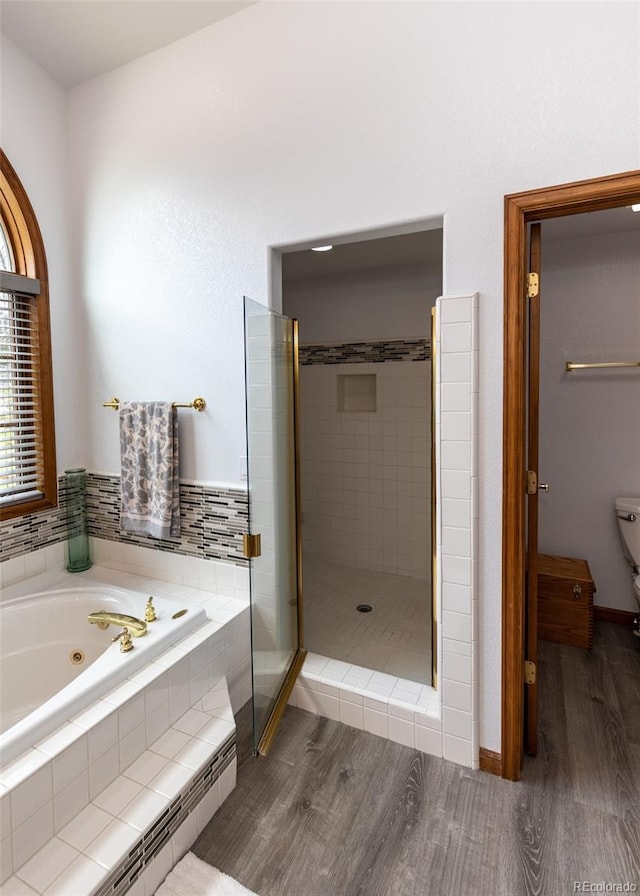 1660 Old Antlers Way, Monument, CO 80132 - bathroom with wood finished floors, a tub with jets, and a stall shower