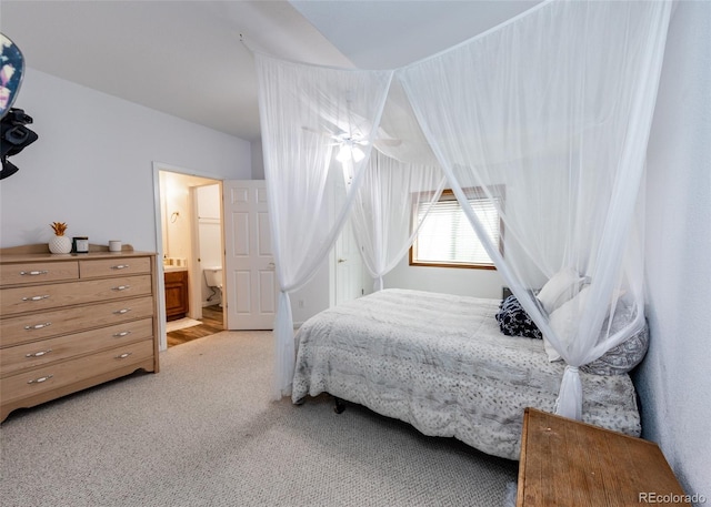 1660 Old Antlers Way, Monument, CO 80132 - bedroom with light colored carpet, vaulted ceiling, and ensuite bathroom