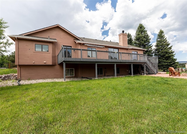 1660 Old Antlers Way, Monument, CO 80132 - rear view of property featuring a wooden deck, stairway, a chimney, and a lawn