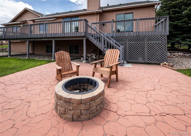 1660 Old Antlers Way, Monument, CO 80132 - view of patio / terrace with an outdoor fire pit, a wooden deck, and stairs