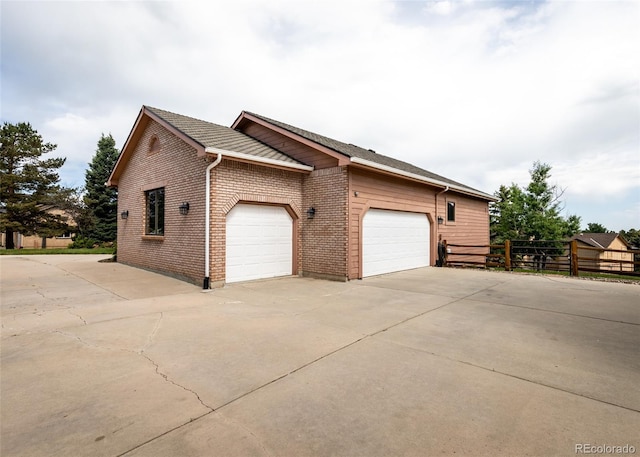1660 Old Antlers Way, Monument, CO 80132 - view of side of property with concrete driveway, a garage, and brick siding