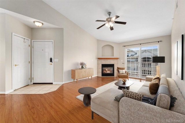7440 S Blackhawk St Unit 7-303, Englewood, CO 80112 - living room with wood finished floors, a ceiling fan, a fireplace, and baseboards