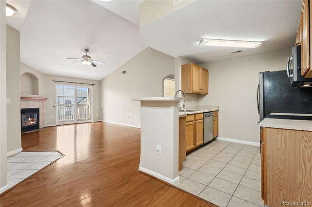 7440 S Blackhawk St Unit 7-303, Englewood, CO 80112 - kitchen featuring appliances with stainless steel finishes, a ceiling fan, a sink, open floor plan, and a peninsula