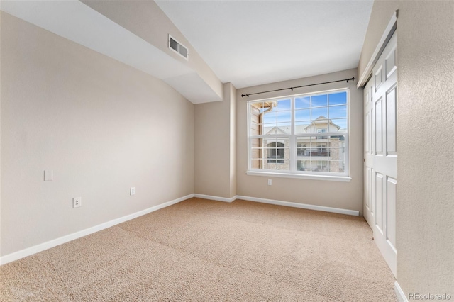 7440 S Blackhawk St Unit 7-303, Englewood, CO 80112 - carpeted empty room featuring baseboards and vaulted ceiling