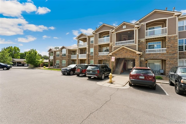 7440 S Blackhawk St Unit 7-303, Englewood, CO 80112 - view of building exterior featuring uncovered parking