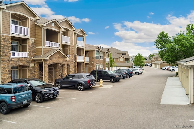 7440 S Blackhawk St Unit 7-303, Englewood, CO 80112 - view of building exterior featuring a residential view and uncovered parking