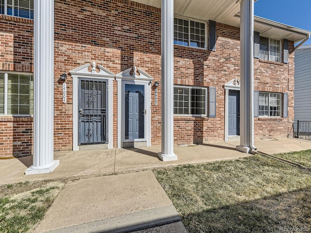 doorway to property with brick siding