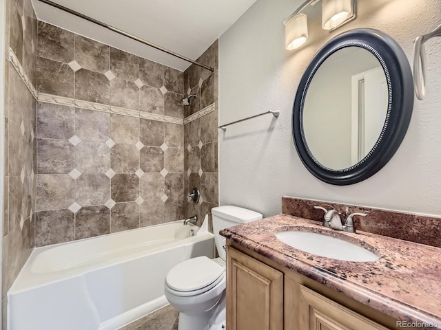 bathroom featuring vanity, shower / bathing tub combination, toilet, and a textured wall