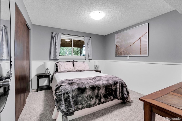 bedroom with a closet and a textured ceiling