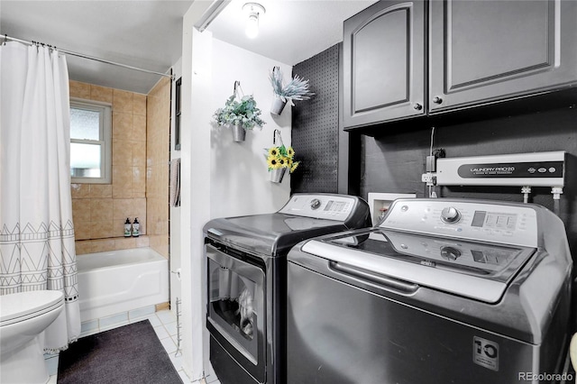 laundry room with laundry area, washer and clothes dryer, and light tile patterned flooring