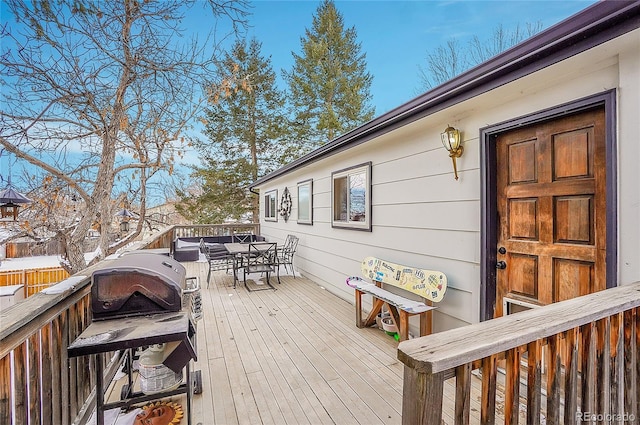 wooden deck featuring outdoor dining area