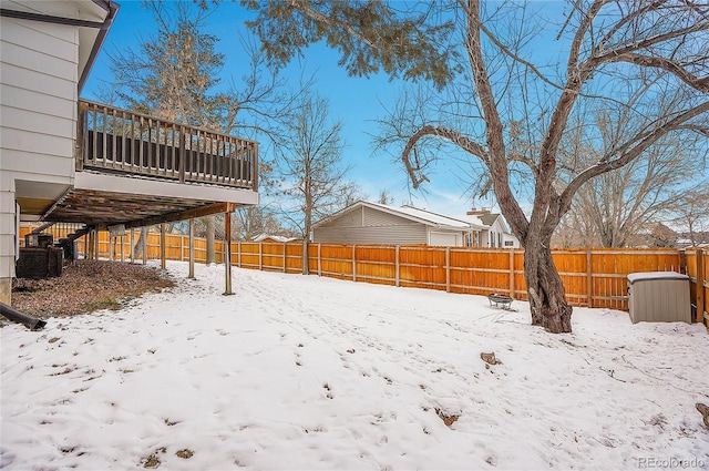 yard covered in snow with a fenced backyard