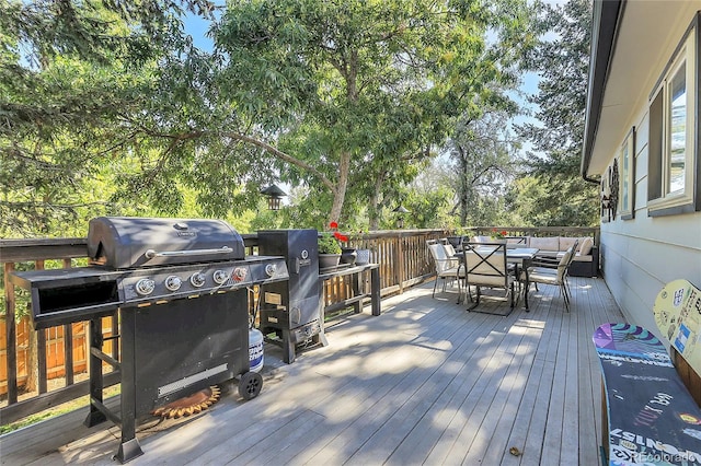 deck featuring a grill and outdoor dining space