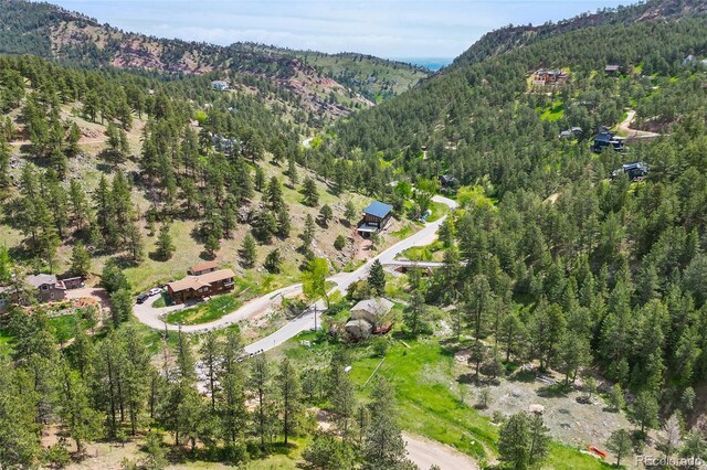 1037 Wagonwheel Gap Rd, Boulder, CO 80302 - aerial overview of property's location featuring a forest and a mountainous background