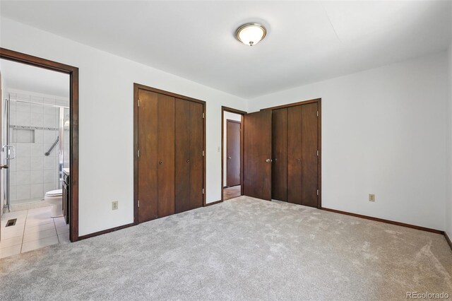 1037 Wagonwheel Gap Rd, Boulder, CO 80302 - unfurnished bedroom with light carpet, multiple closets, baseboards, and ensuite bathroom