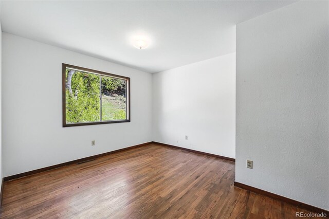 1037 Wagonwheel Gap Rd, Boulder, CO 80302 - spare room featuring wood finished floors and baseboards