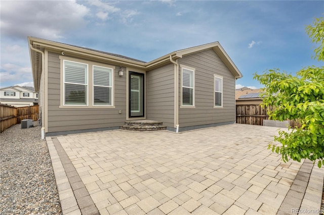 27639 E 7th Ln, Aurora, CO 80018 - back of house with a patio, a fenced backyard, and central AC unit