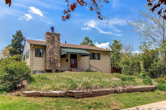 1275 Niagara St, Denver, CO 80220 - view of front facade featuring a chimney and a shingled roof