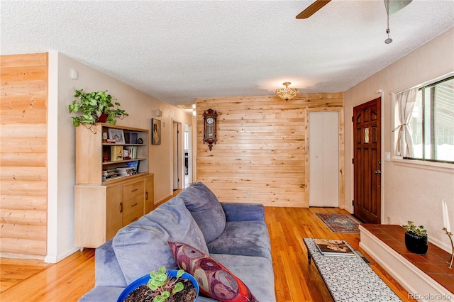 1275 Niagara St, Denver, CO 80220 - living room featuring a textured ceiling, wood finished floors, and a ceiling fan
