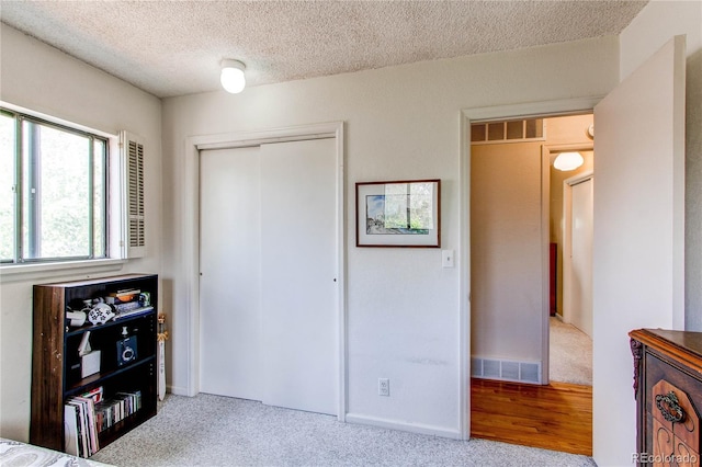 1275 Niagara St, Denver, CO 80220 - unfurnished bedroom with a closet, a textured ceiling, baseboards, and carpet flooring