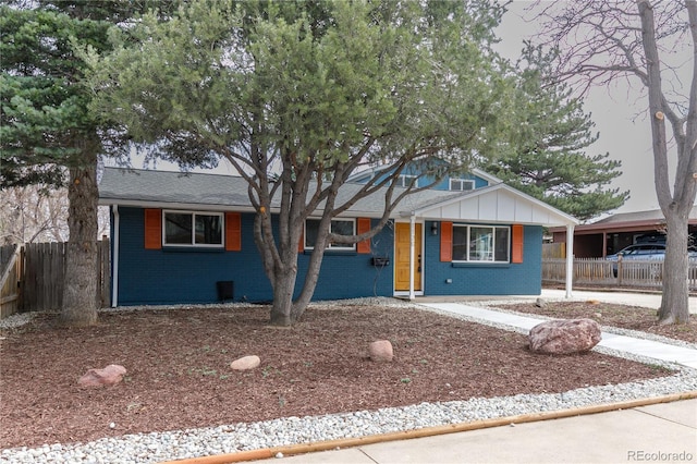 1120 Hartford Dr, Boulder, CO 80305 - view of front of home featuring brick siding, a shingled roof, and board and batten siding