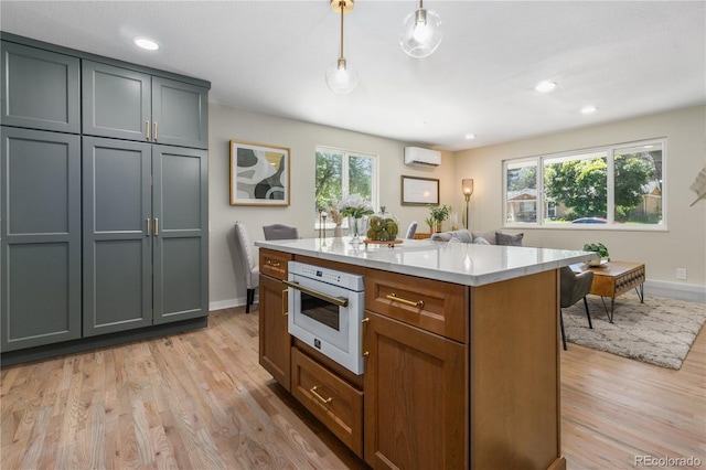 1120 Hartford Dr, Boulder, CO 80305 - kitchen with white oven, an AC wall unit, healthy amount of natural light, light wood finished floors, and recessed lighting