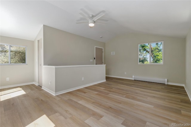 1120 Hartford Dr, Boulder, CO 80305 - unfurnished room featuring a baseboard radiator, vaulted ceiling, a ceiling fan, and light wood-style flooring