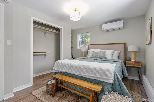 1120 Hartford Dr, Boulder, CO 80305 - bedroom featuring an AC wall unit, wood finished floors, and a closet